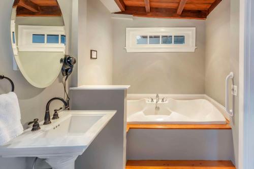 a bathroom with a tub and a sink at Essex Street Inn & Suites, Ascend Hotel Collection in Newburyport