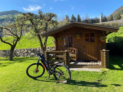 a bike parked in front of a cabin at Gästehaus Ortner in Heinfels