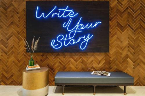 a sign that reads write your story on a wall at Doubletree By Hilton Abilene Downtown Convention Center in Abilene