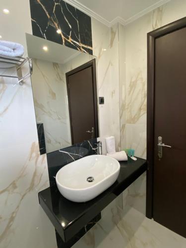 a bathroom with a white sink and a mirror at Selefkos Palace in Igoumenitsa