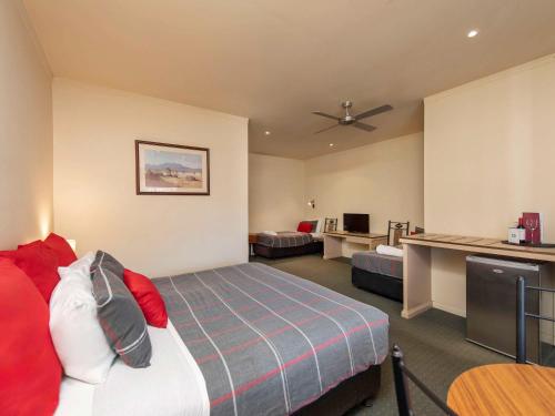 a hotel room with a bed and a desk at Breakfree Port Pirie in Port Pirie