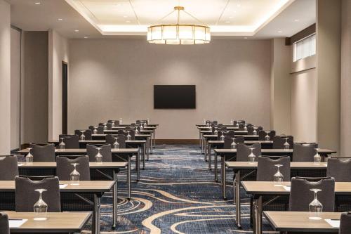 a conference room with tables and a screen at Doubletree By Hilton Abilene Downtown Convention Center in Abilene