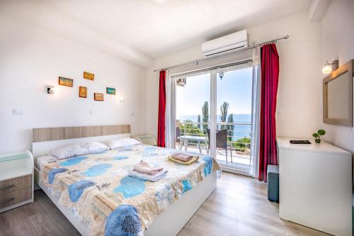 a bedroom with a bed and a large window at Villa Tesla in Ohrid