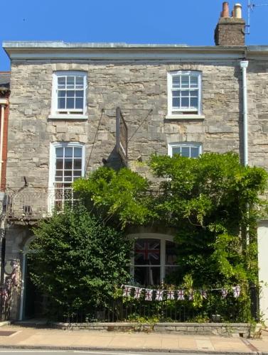 a stone house with a tree in front of it at The Casterbridge in Dorchester