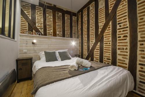 une chambre avec un grand lit et des murs en bois dans l'établissement Le Cœur De La Scellerie - Hypercentre - Netflix, à Tours