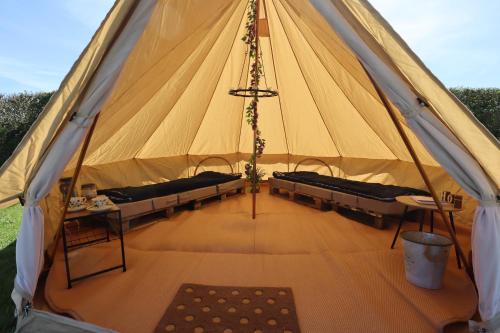 a large tent with benches and a table in it at Rescorla Retreats - Ivory in St Austell
