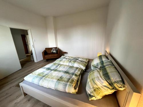a bedroom with two pillows on a bed with a chair at Soleblick in Salzelmen