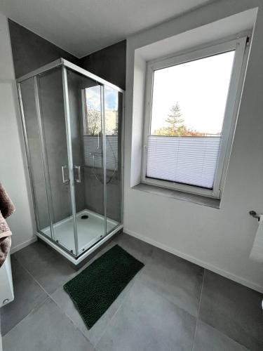 a bathroom with a shower and a large window at Soleblick in Salzelmen