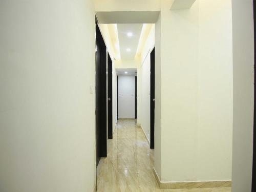 a hallway with black and white walls and wood floors at OYO Hotel Dream Inn in Sarkhej