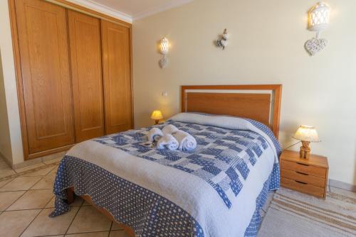 um quarto com uma cama com dois cães deitados sobre ela em Urban Beach - Casa MM em Carvoeiro
