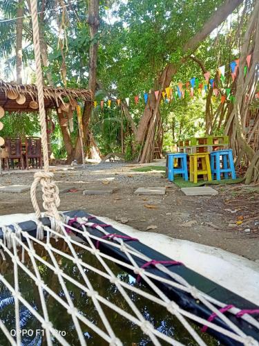 a picnic area with a rope and tables and flags at Do Dee cafe in Bangkok
