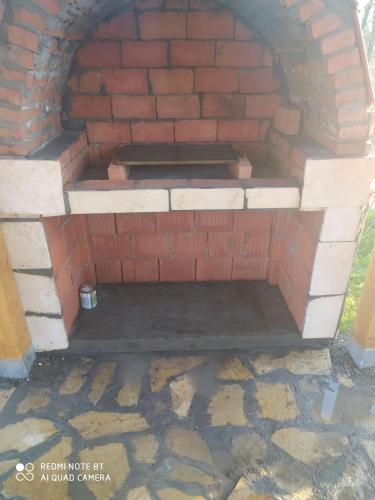 a brick oven with a bench inside of it at Eko kuća Zlatiborsko srce in Zlatibor