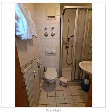 a bathroom with a shower and a toilet and a sink at Fewo Auszeit am Königssee in Schönau am Königssee