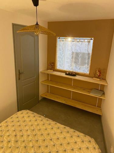 a bedroom with a bed and a window at Appartement cocooning a ruaux in Plombières-les-Bains