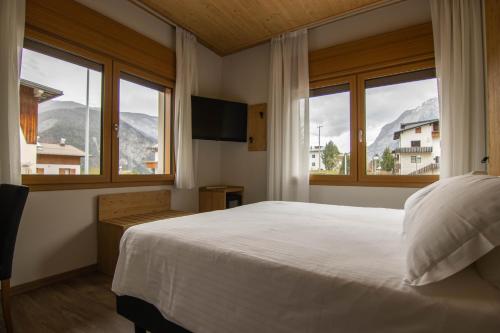 Postel nebo postele na pokoji v ubytování Chalet Cridola Dolomiti Experience