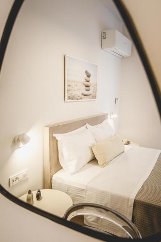 a bedroom with a bed and a mirror at Votsalo Tolo in Tolo