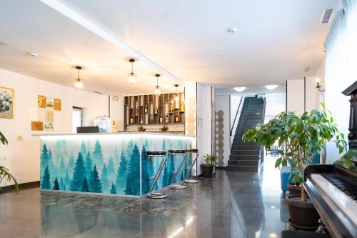 a bar in a room with trees on the floor at Pensiunea Hilltop in Predeal