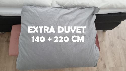 a bag that says extra duvet and cm on a bed at Itilleq in Sisimiut