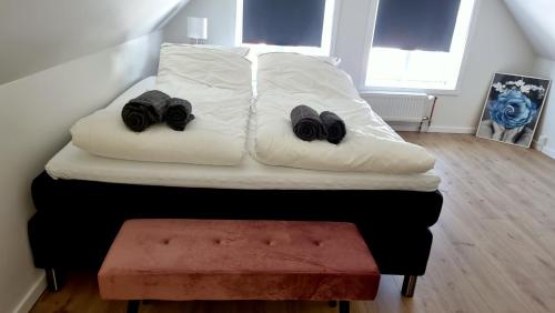 a bed with two pairs of shoes on it at Itilleq in Sisimiut