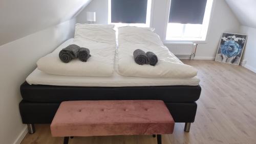 a bed with two pairs of shoes on top of it at Itilleq in Sisimiut