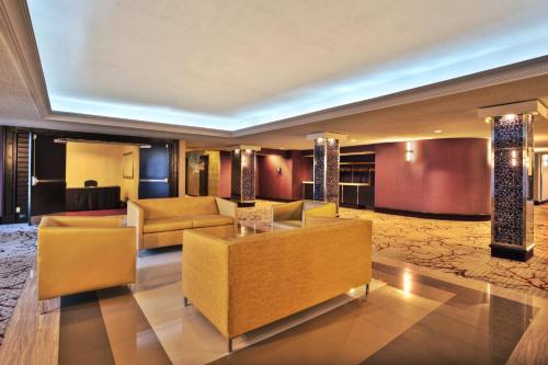 a living room with couches and tables in a building at Crowne Plaza Kitchener-Waterloo by IHG in Kitchener