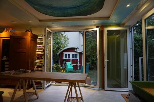 a room with a table and a sliding glass door at Eva Und Wolf Apartments in Sachsenheim