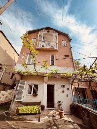 a building with windows and a bench in front of it at Sky Guest House in Tbilisi City