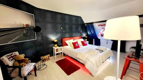 a bedroom with a bed and a teddy bear at VILLA RAFFAELLA in Les Albres