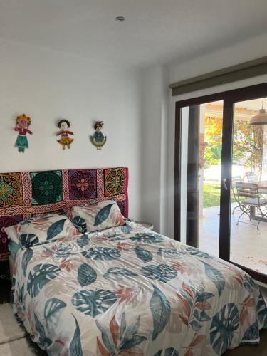 a bedroom with a bed with a colorful comforter at Villa Santorini in Torre de Benagalbón