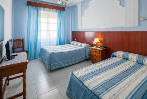 Un pat sau paturi într-o cameră la Hotel Restaurante Los Molinos