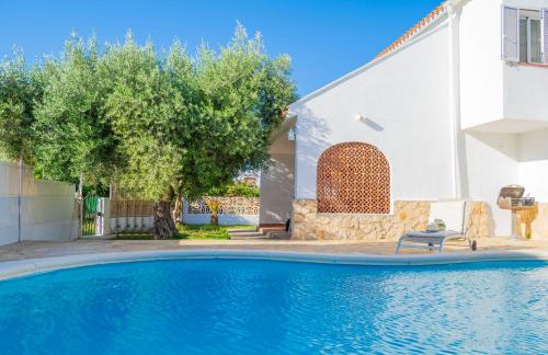 a swimming pool in front of a house at Casa Delicias con Piscina Privada a 200m playa - By Marina Alta Holidays in Denia