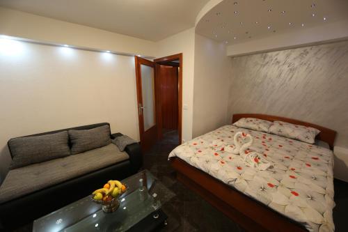 a bedroom with a bed and a couch at Villa Maki in Ohrid