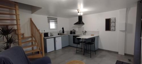 a small kitchen with a counter and a table at LE RANCON gite des Abbayes du Val de Seine in Sainte-Marguerite-sur-Duclair