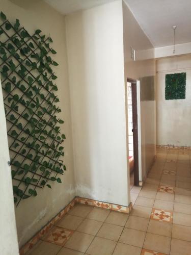 a room with a wall with a plant on the wall at Mona Lisa Guest House, Kisumu in Kisumu