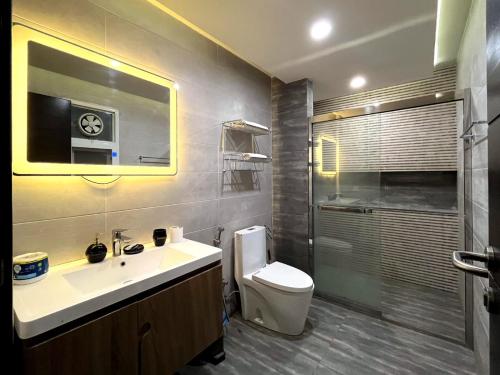 a bathroom with a sink and a toilet and a shower at Luxury 1-Bed Apt Ideal for Couples in Islamabad
