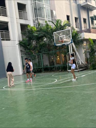 a group of people playing basketball on a court at Luxury Resort Condo in Pasig FastWifiPoolSmartLock in Manila