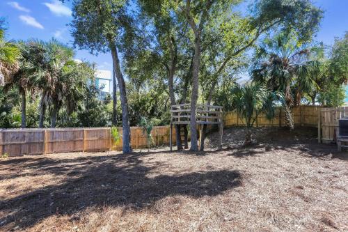 a park with a bench and trees and a fence at Eagle's Rest by Pristine Properties Vacation Rentals in Indian Pass