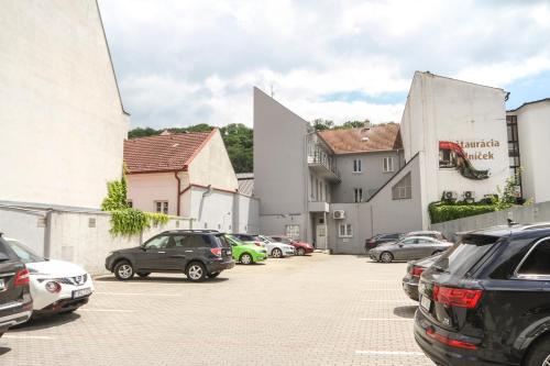 a group of cars parked in a parking lot at Apartmán Vita Design in Trenčín
