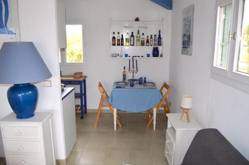 a living room with a table and a blue lamp at Alamic in Grimaud