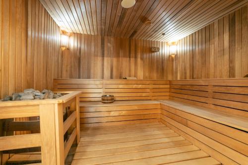 a sauna with wooden walls and a wooden floor at Hotel Sato Conference & SPA Resort in Sutomore