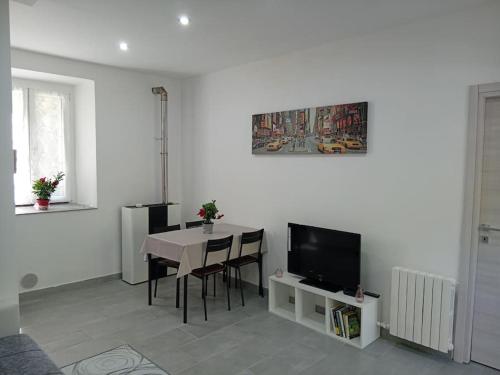 a living room with a table and a television at CASA TURRI in Como