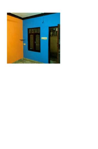 a room with a blue wall and a door at mogappair esat in Chennai