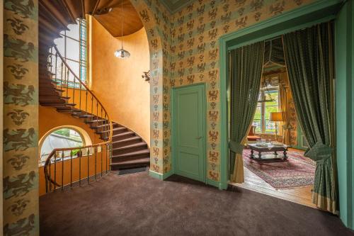 a hallway with a spiral staircase in a house at Leyselebeke Castle in Bruges