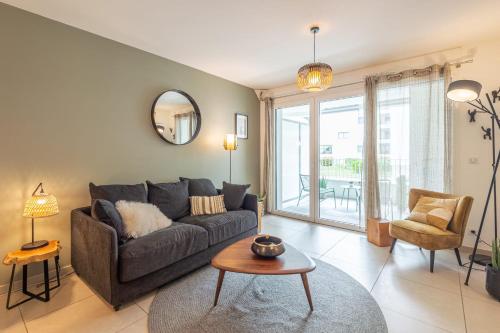 a living room with a couch and a table at L'Interprète 405 4 - Apartment with terrace in Annecy