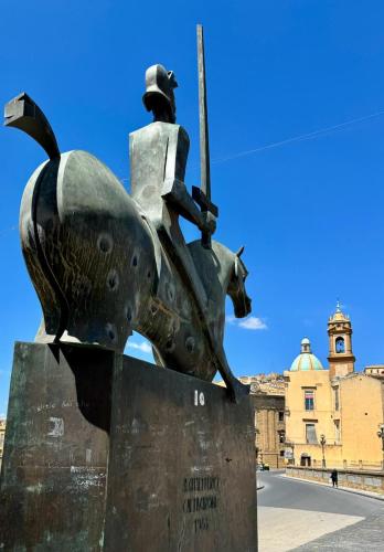 a statue of a man on a horse with a sword at Casa vacanze in centro! in Caltagirone