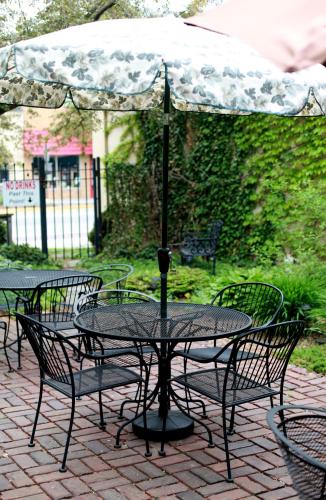 a table and chairs with an umbrella on a patio at The Winter Inn in Greenville