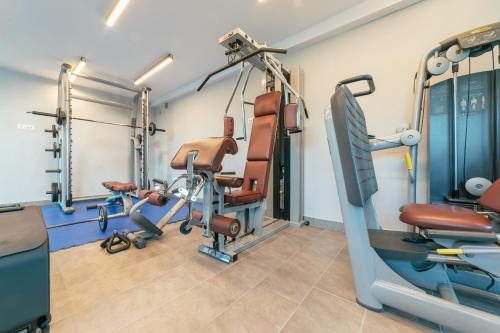 a gym with treadmills and machines in a room at Hotel Sato Conference & SPA Resort in Sutomore