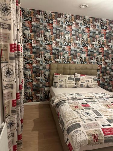 a bedroom with a bed with a wall covered in baseball pictures at Coxwell in Mill Hill