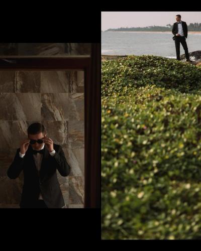 a man in a suit and sunglasses talking on a cell phone at New Ocean Hill Hotel in Hikkaduwa