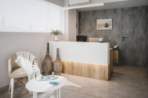 a living room with a table and a white counter at Votsalo Tolo in Tolo